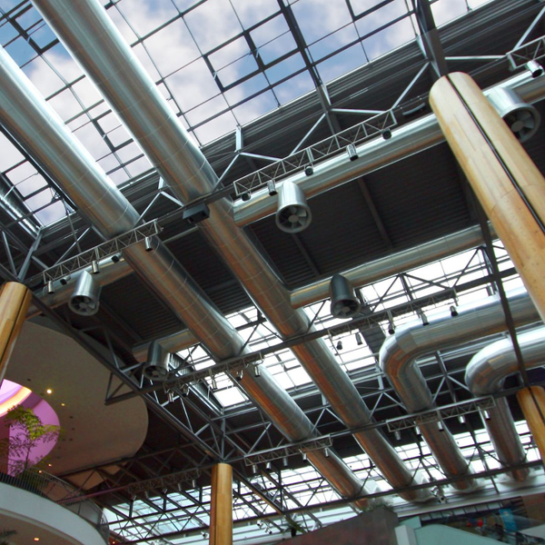 large atrium, glass ceilings, array of large HVAC pipes