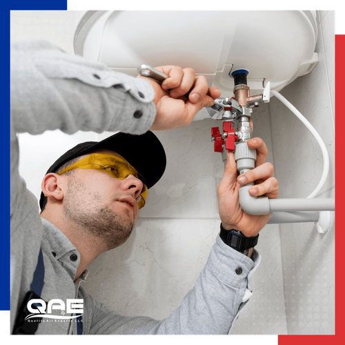 a residential plumber tightening a fitting
