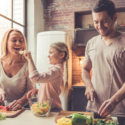 Happy family cooking dinner together.