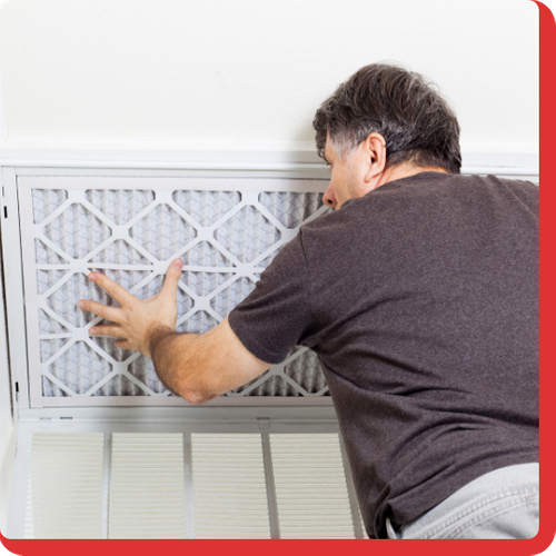 A man installing an ac filter