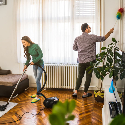 Couple cleaning a room