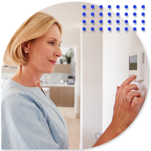 person adjusting thermostat person adjusting thermostat