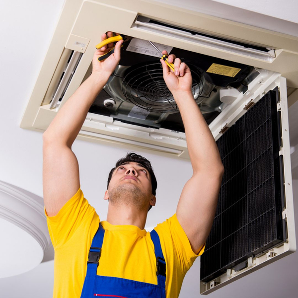 A man fixing an ac unit