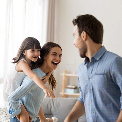 Happy family smiling and having fun in the living room.