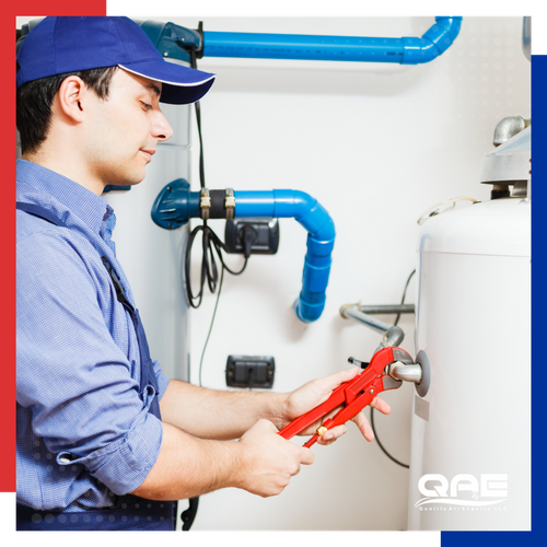 plumber working on hot water heater 
