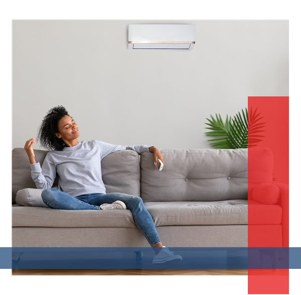 Happy woman relaxing on the couch and enjoying air conditioning.