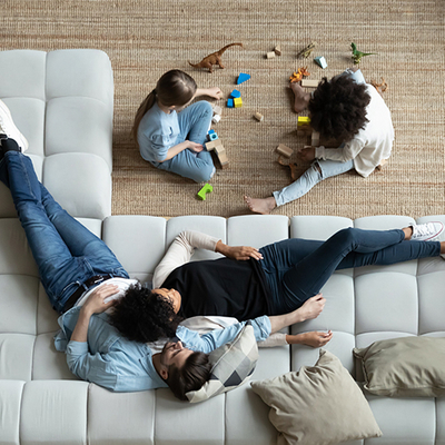 Family relaxing on the floor and sofa.