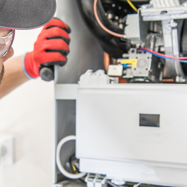  A man checking furnace equipment.