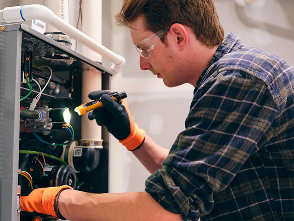 man looking at furnace