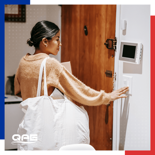 woman adjusting her thermostat