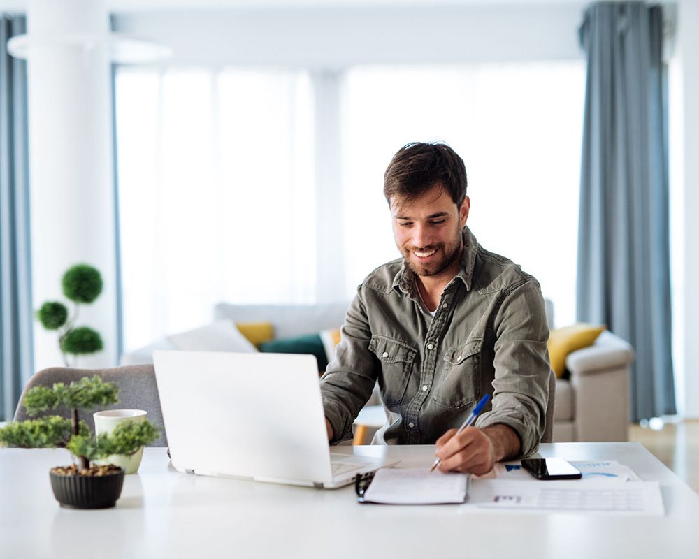 smiling man taking online class