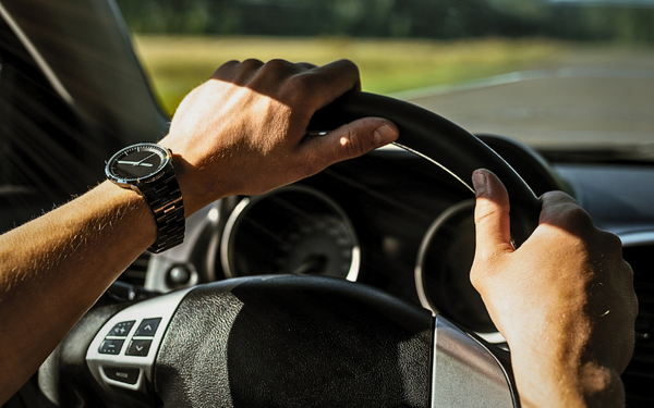 man driving a truck on a highway