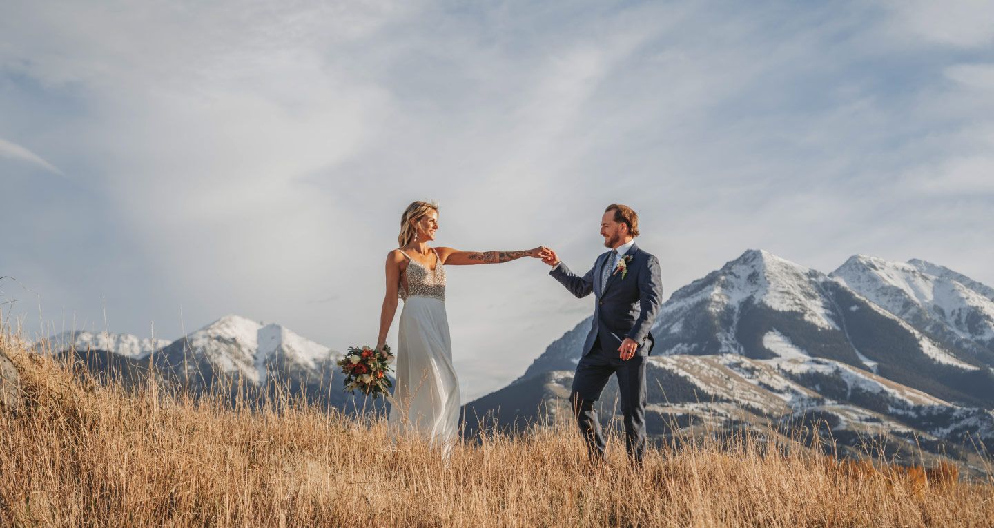 1440x765-Bride-and-groom-holding-hands-in-front-of-Emigrant-Peak-at-Sage-Lodge-Resort-and-Montana-Wedding-Venue-Near-Yellowstone-National-Park-v2.jpg