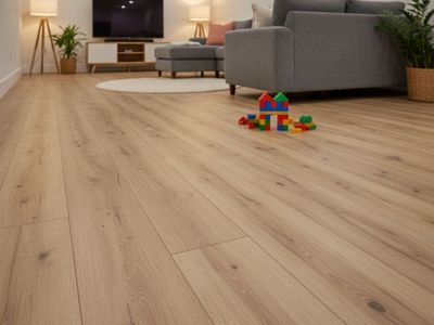 Cozy basement living area with durable wood-look luxury vinyl plank flooring, grey sofa, and playful children's building blocks on the floor.