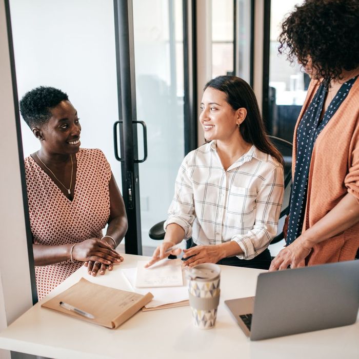 An insurance agent meeting with two small business owners