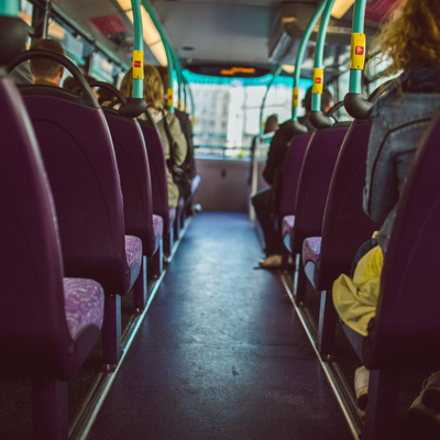 the aisle of a half empty bus of people. Get Involved