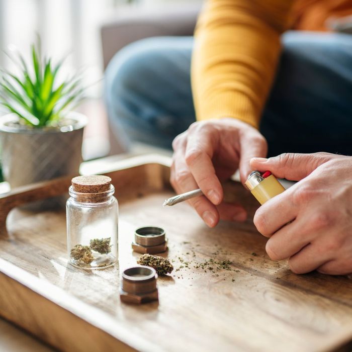 person rolling weed on a rolling tray