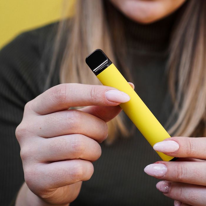 person holding disposable vape