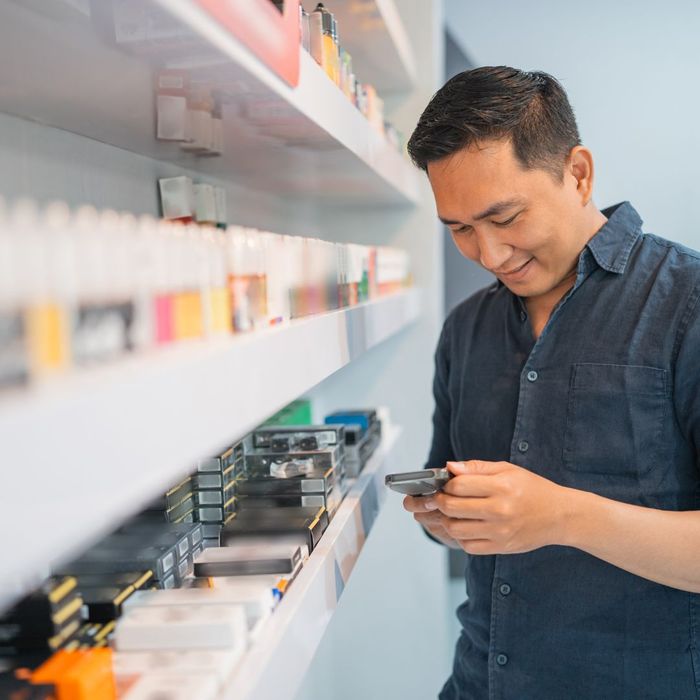 Shop worker grabbing product off the shelf