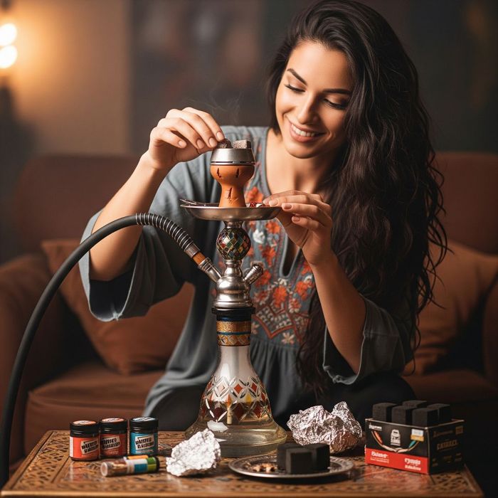A young woman smiling while preparing a hookah