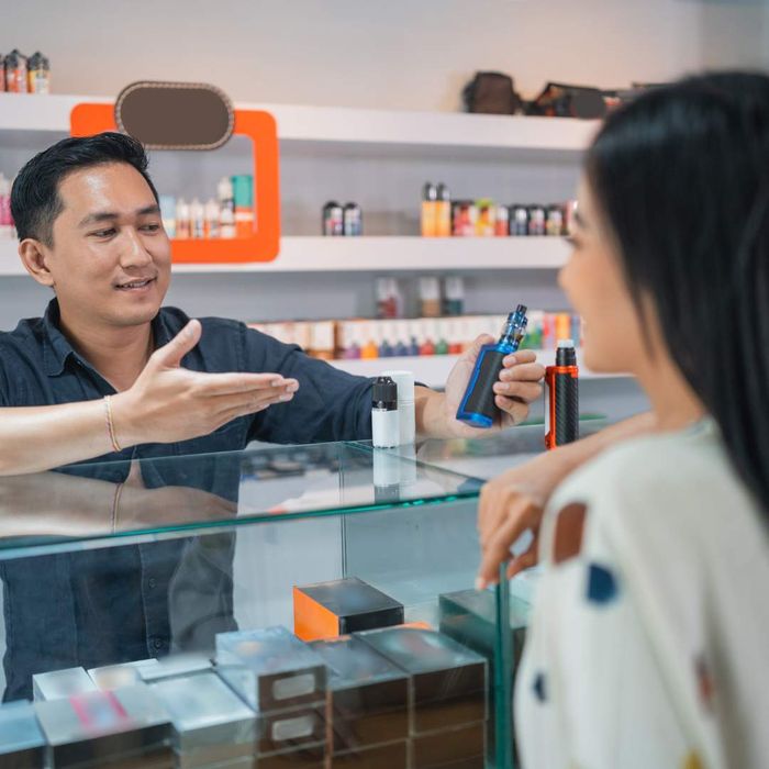 shop owner talking to customer about a vape pen