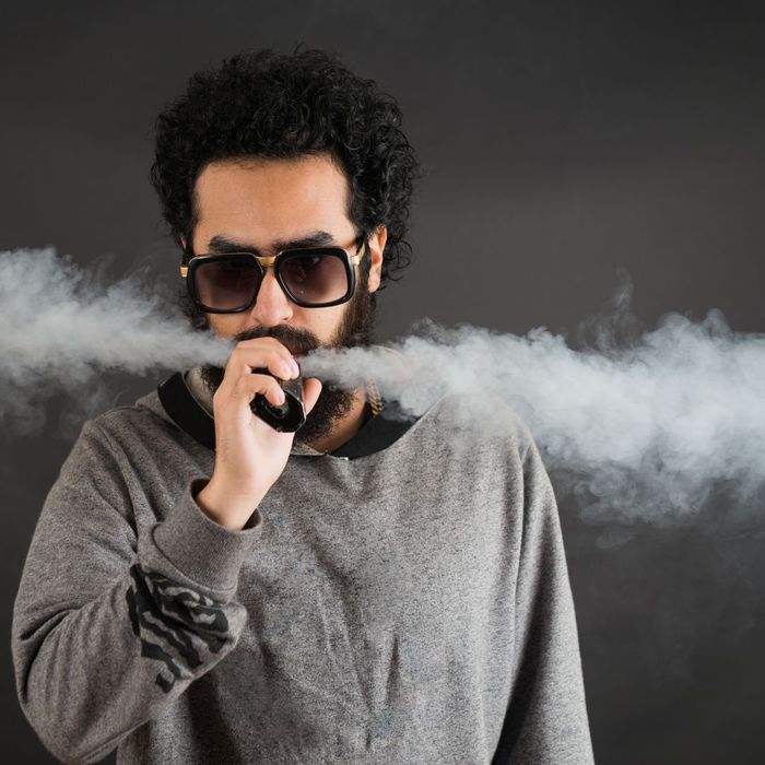 person blowing vape smoke