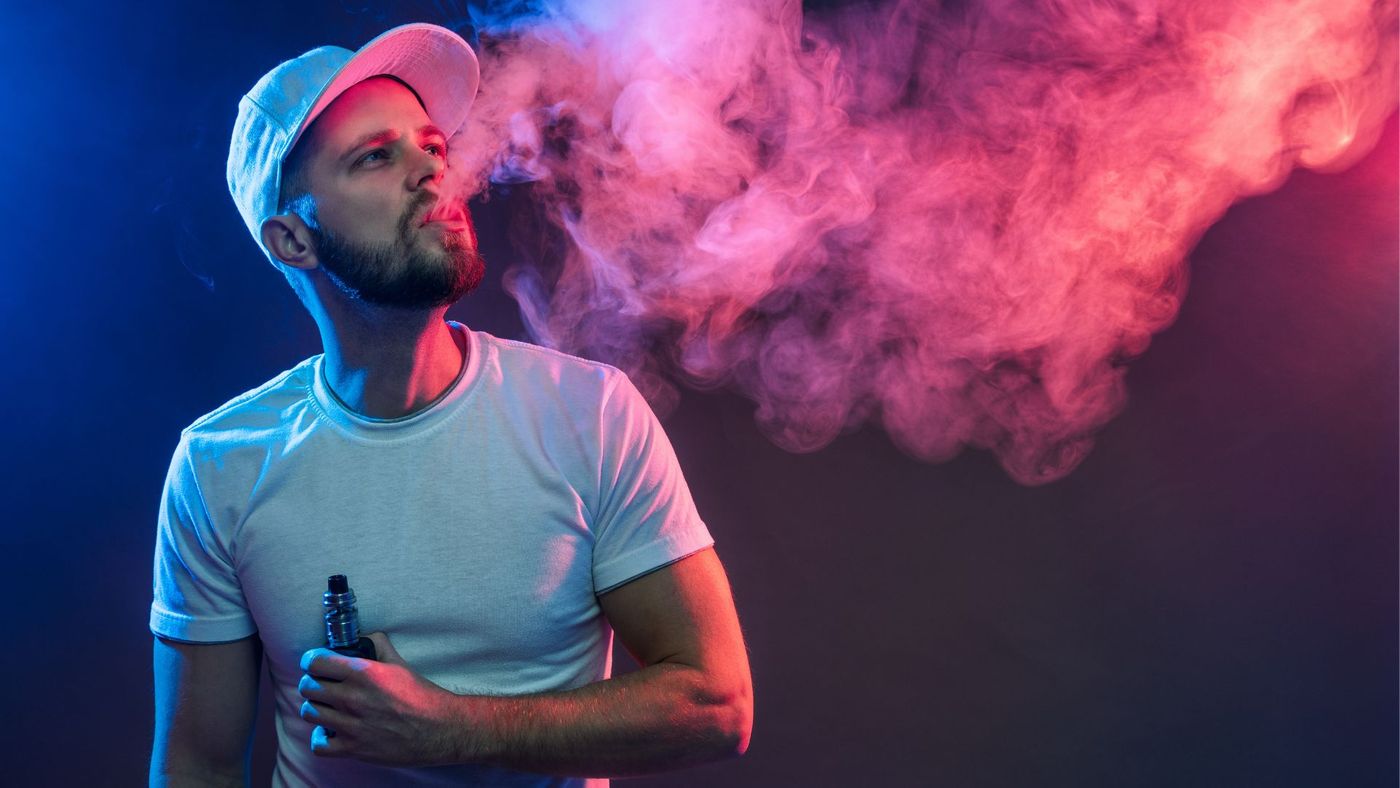 person smoking vape in colorful setting