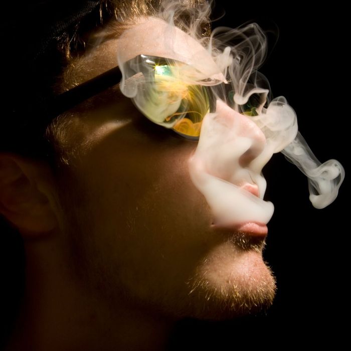 man exhaling smoke