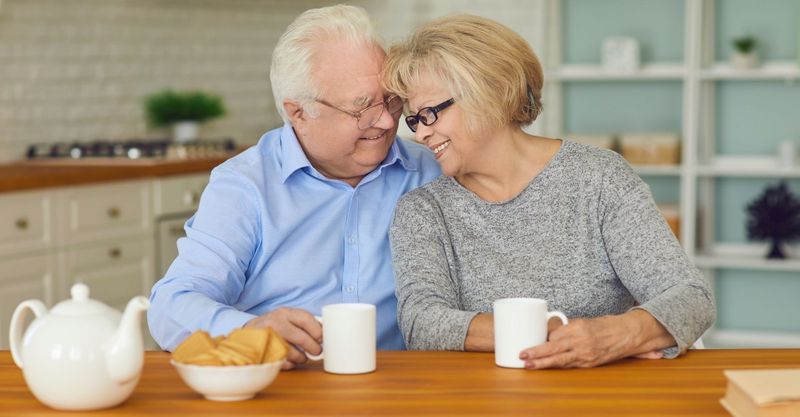 happy senior couple drinking coffee