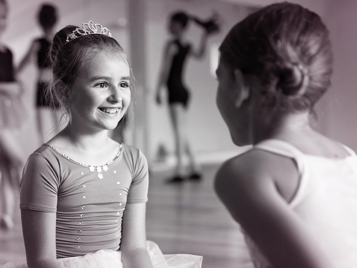 two girls smiling at eachother