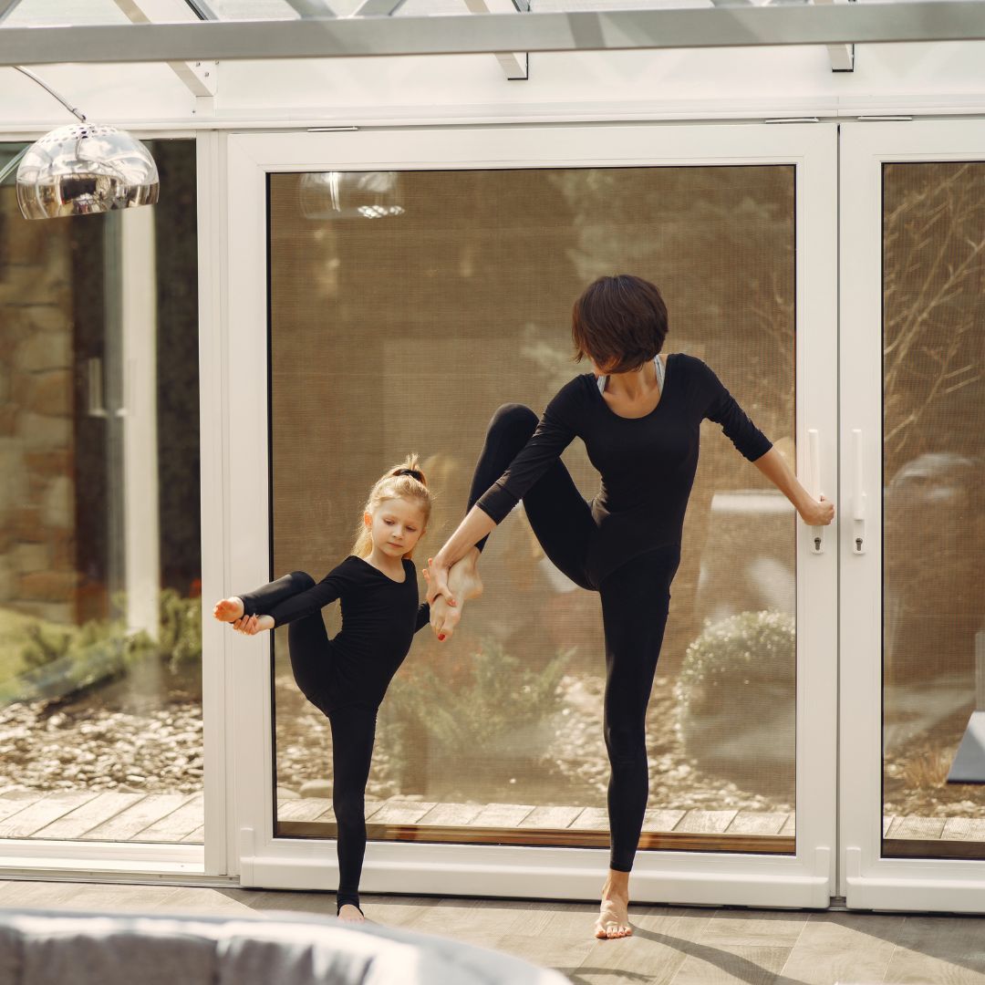 woman teaching a child a dance move