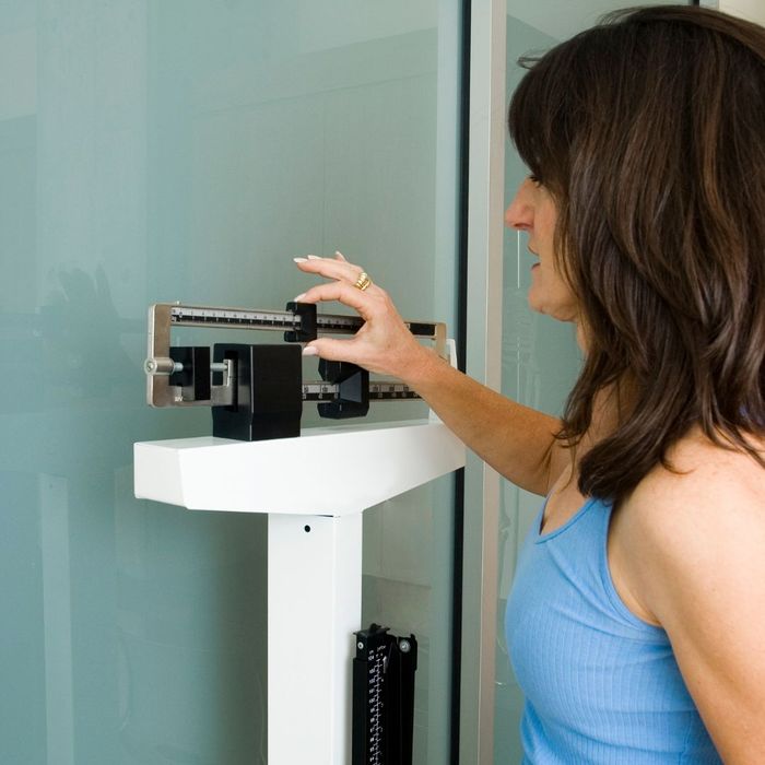 A women weighing herself