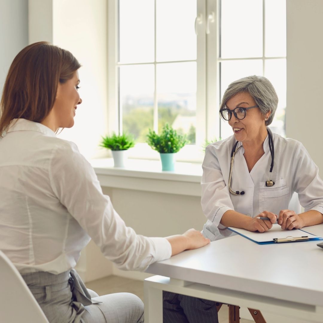 woman discussing hormone replacement therapy with a doctor