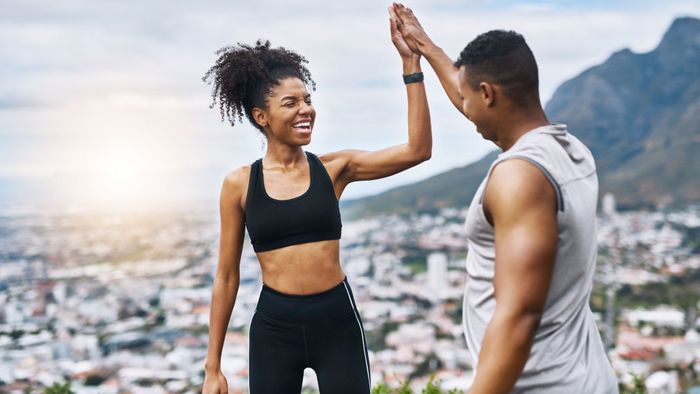 two energized people high-fiving