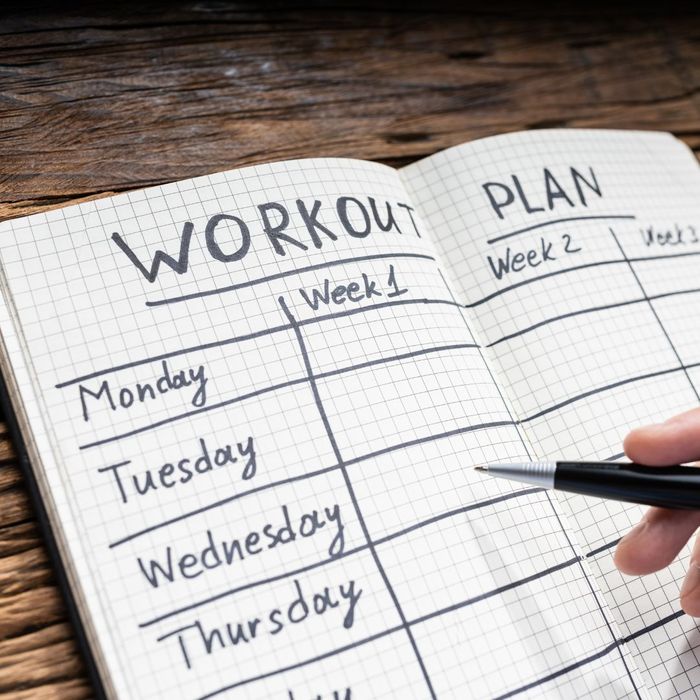 A workout plan written inside a notebook