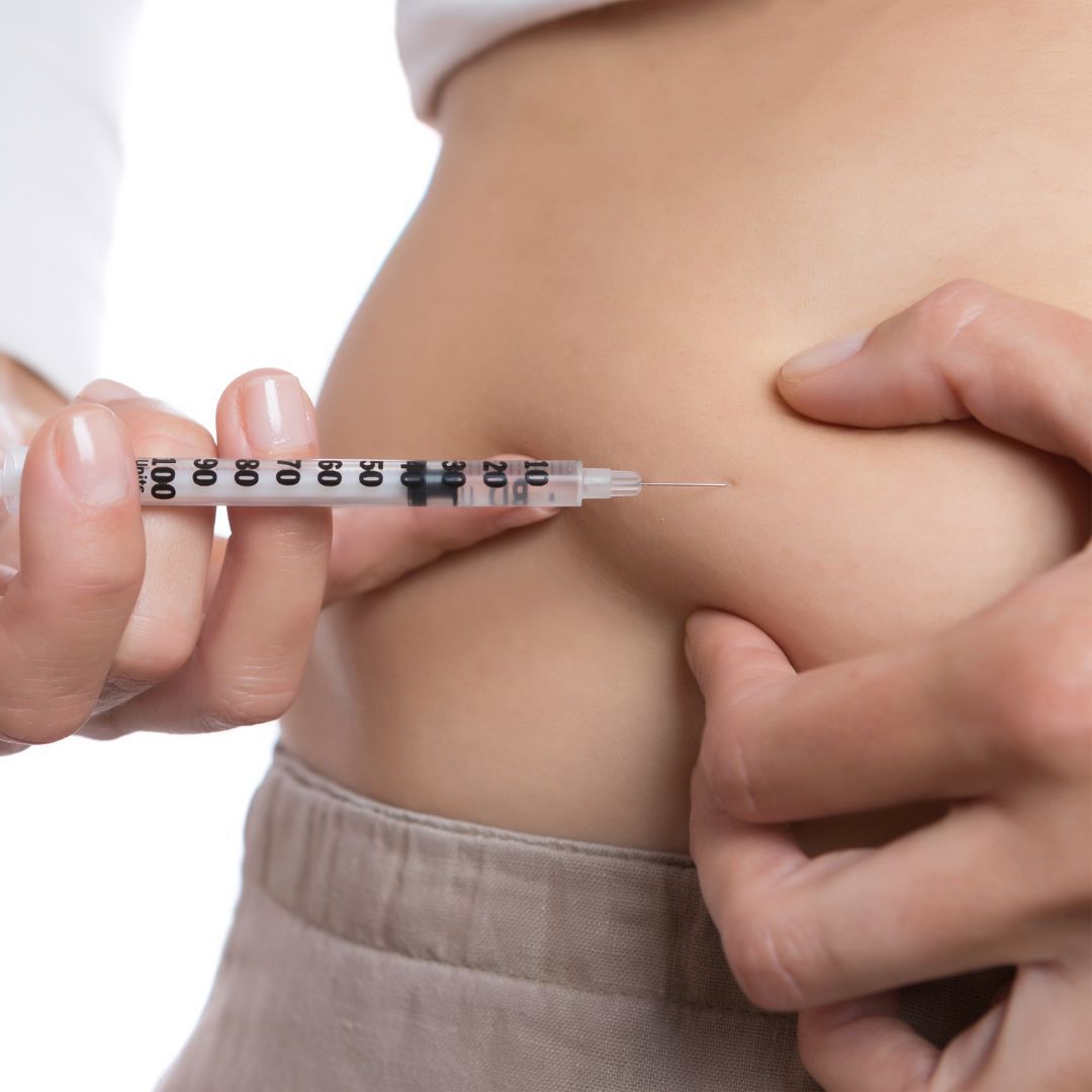 a woman giving herself an injection