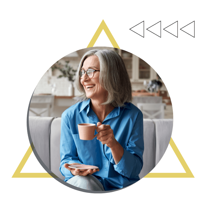 an older woman drinking from a mug