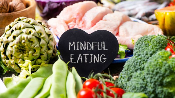 Plate of healthy foods with card reading "mindful eating" 