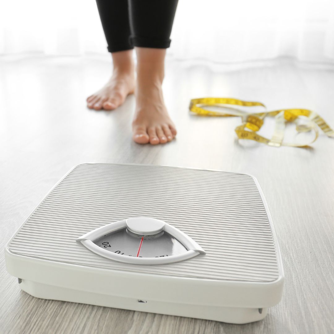 person getting ready to step on the scale