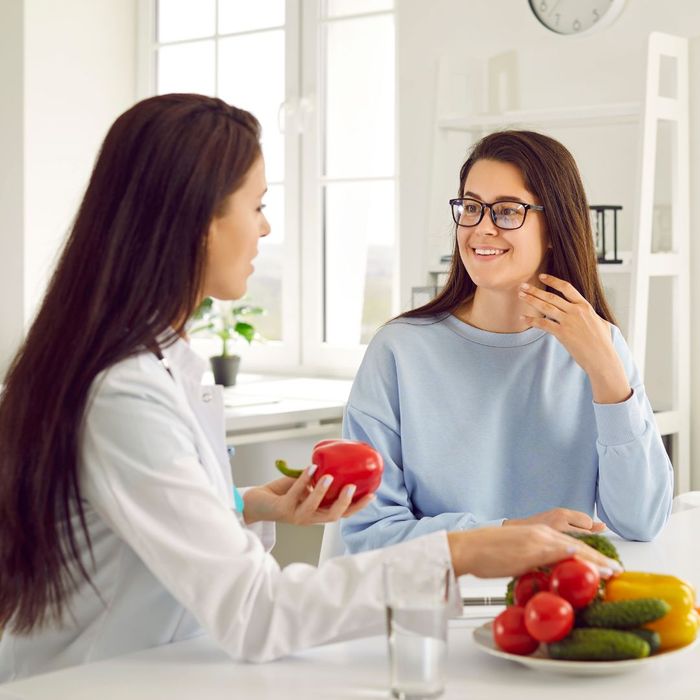 A weight loss consultant discussing the importance of vegetables with a client