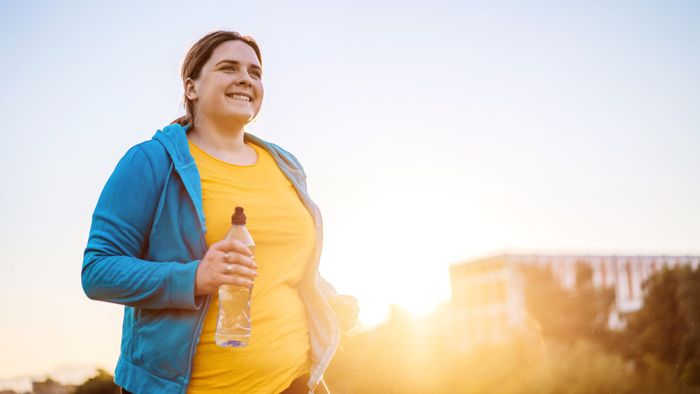 Person running with a water bottle