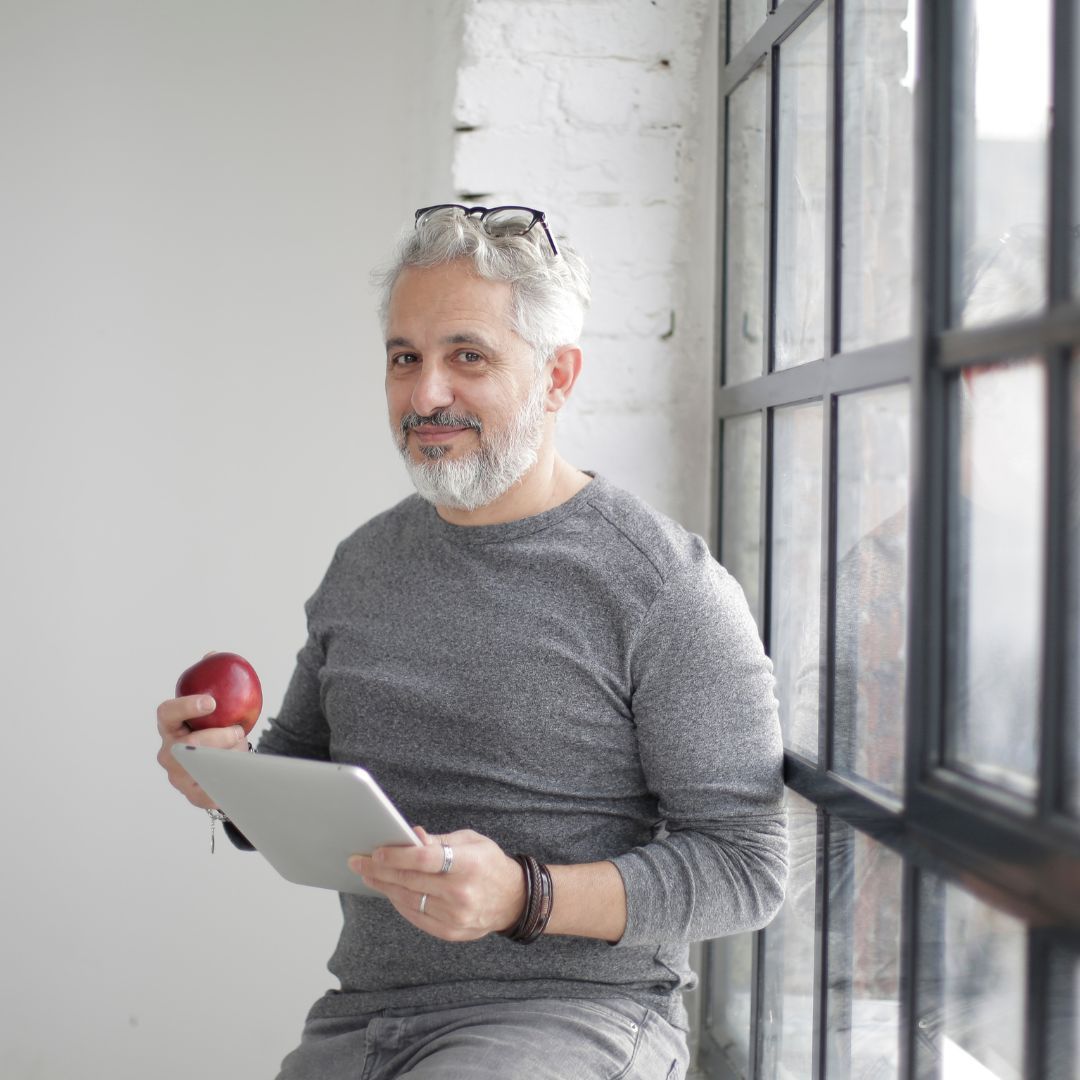 older man eating an apple