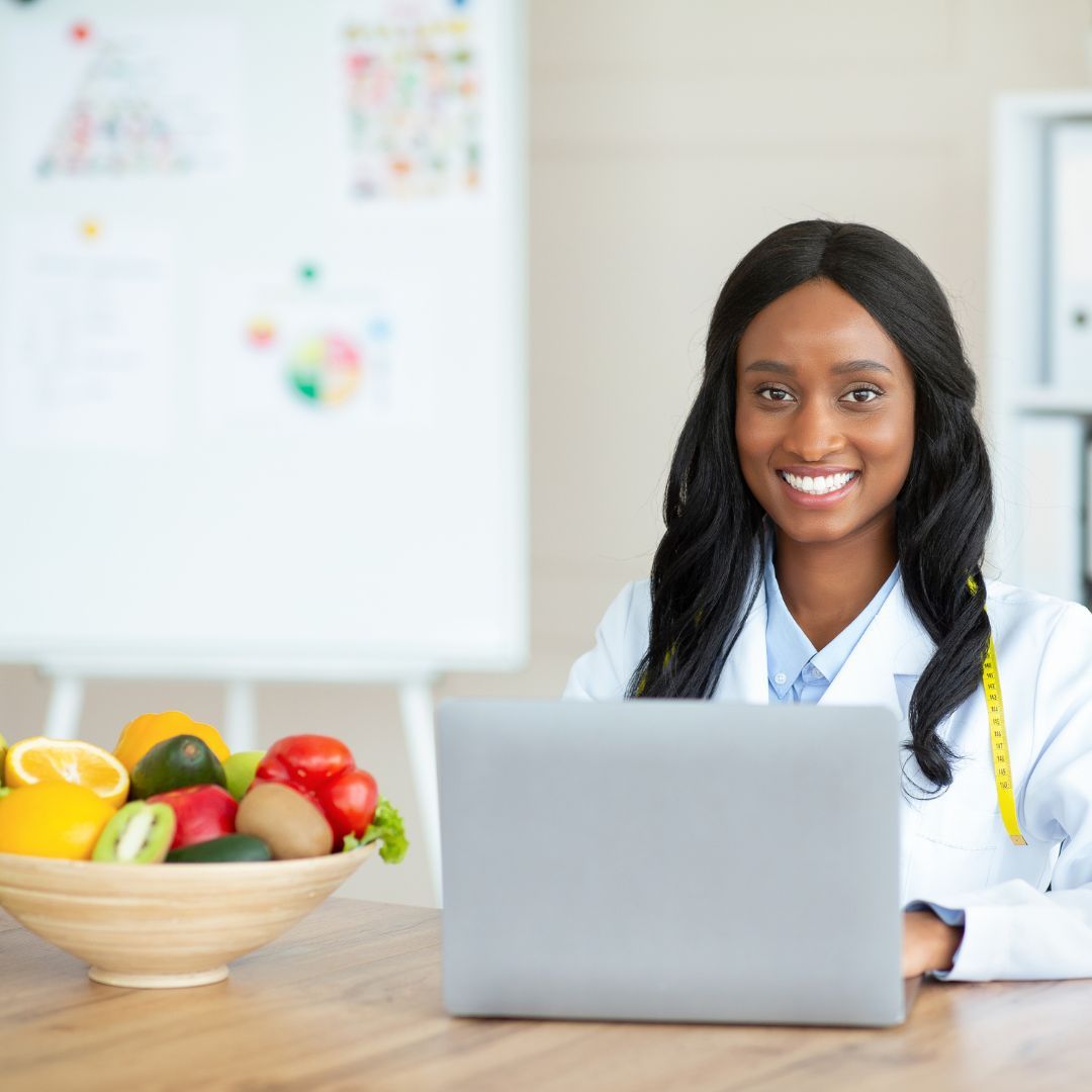 a weight loss consultant sitting in front of a laptop