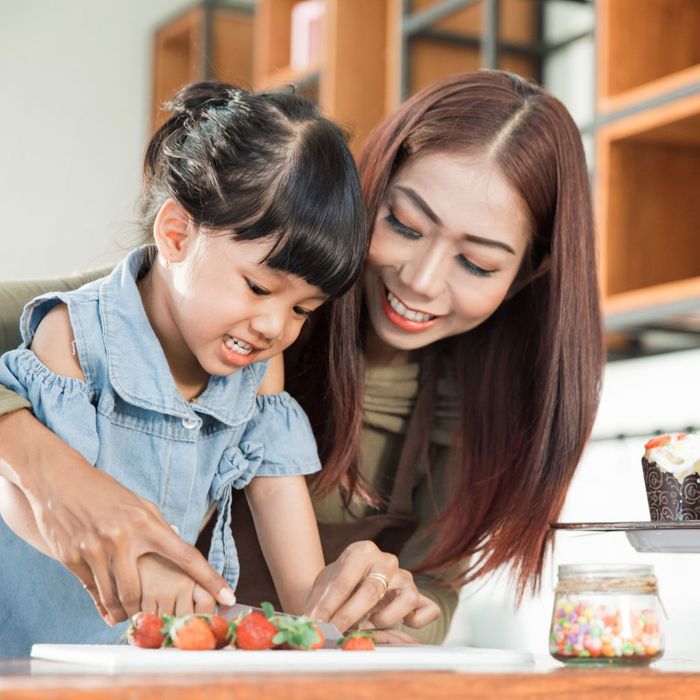 mother and child slicing fruits