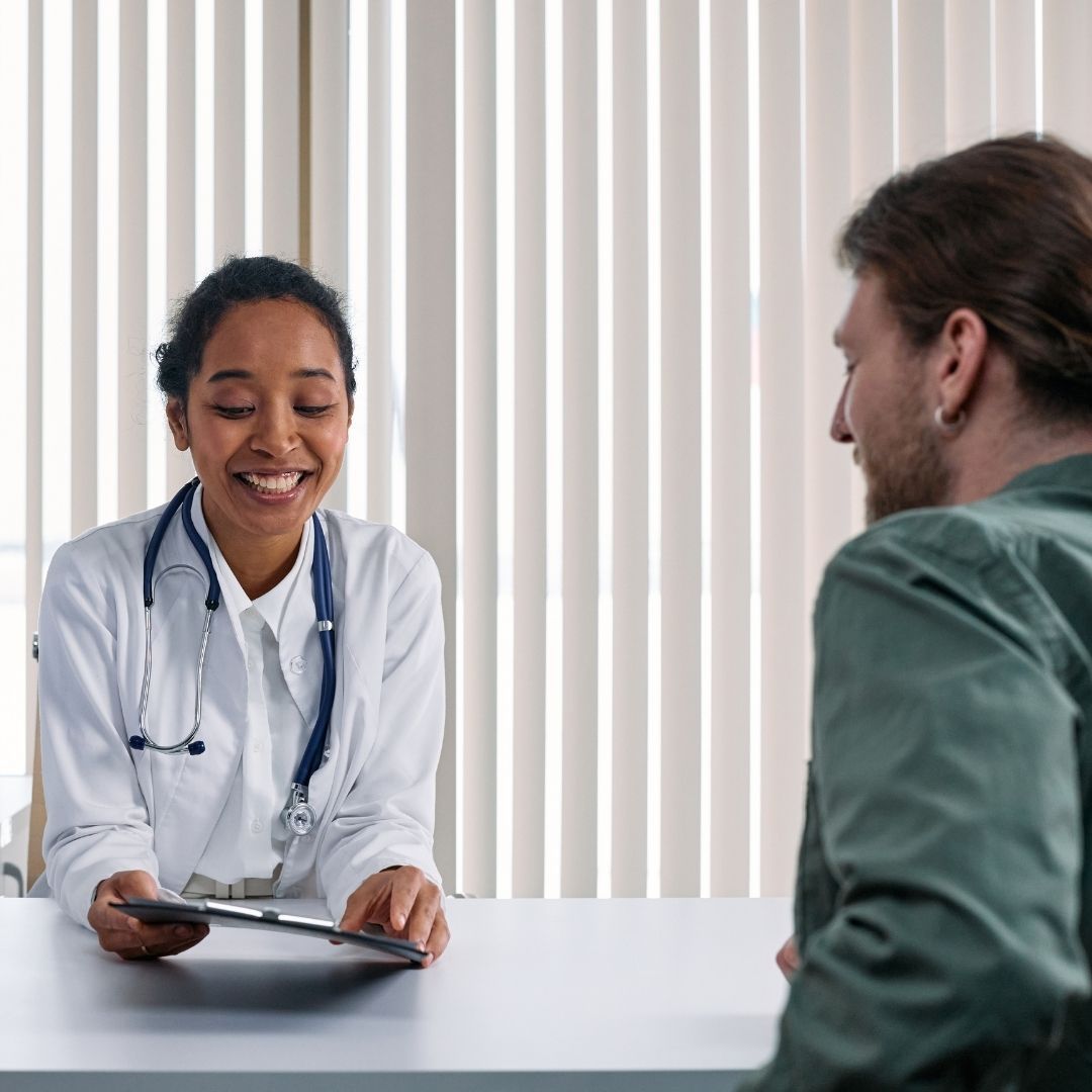 man talking to a doctor about hormone replacement therapy