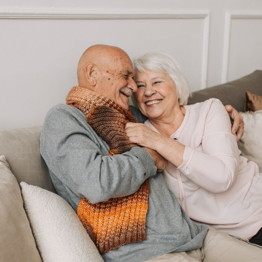 older couple hugging older couple hugging