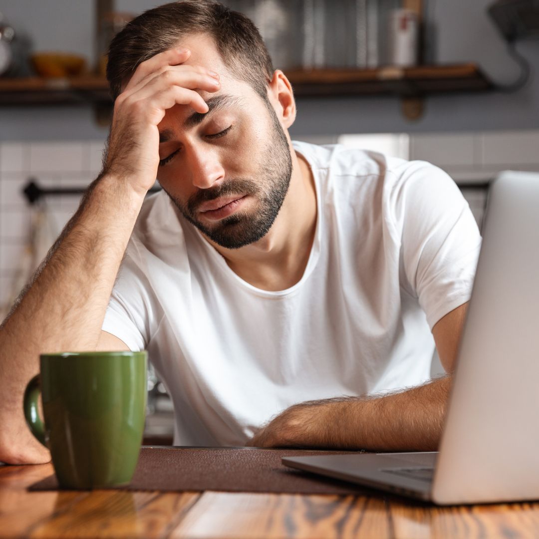 Tired person using a laptop