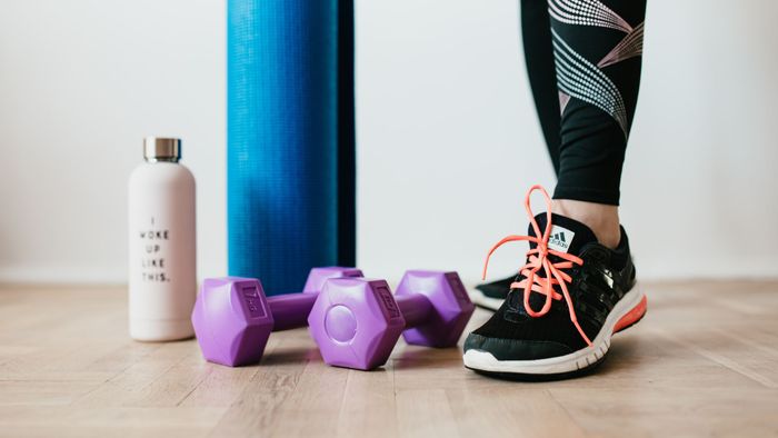 weights, water bottle, and yoga mat in workout studio