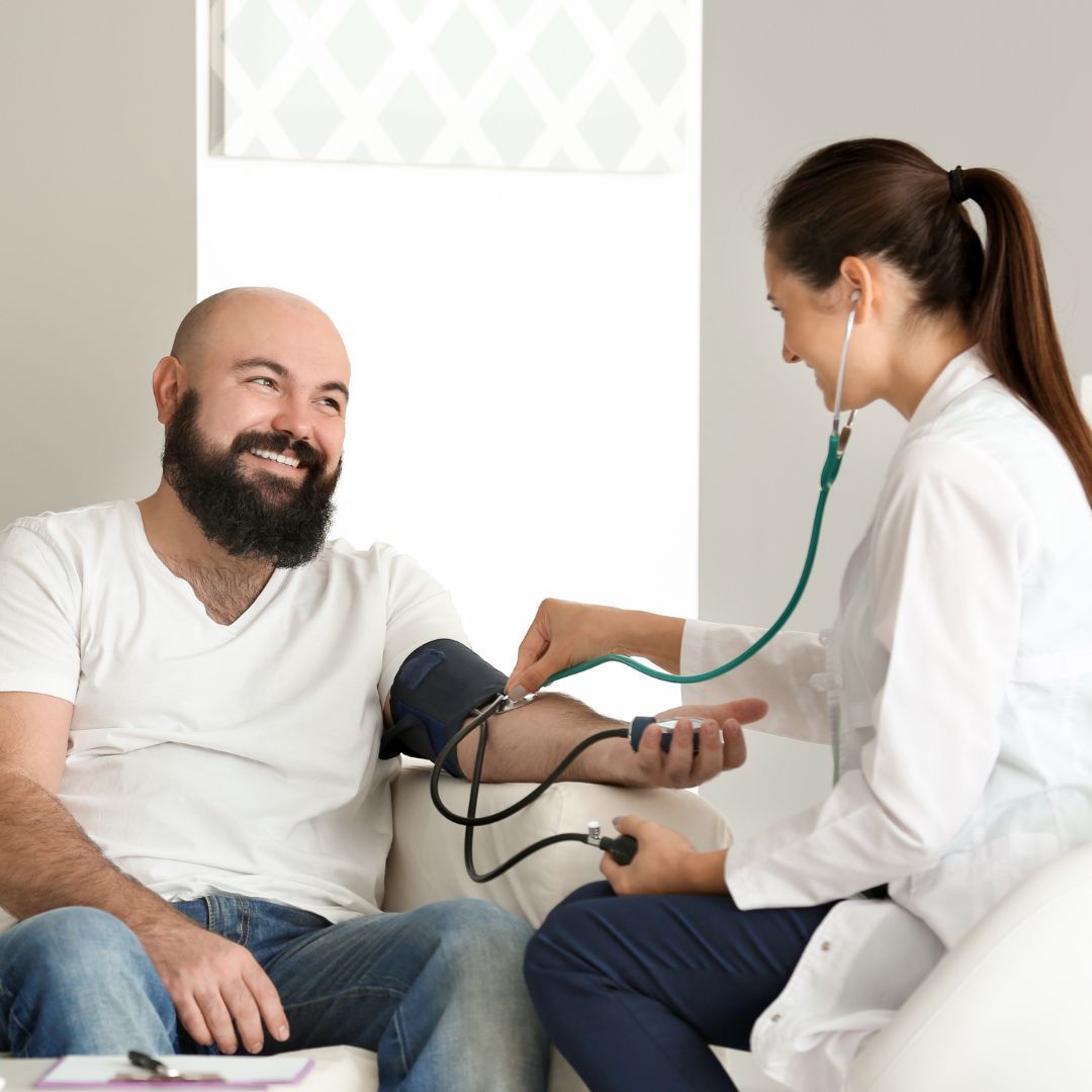 Doctor checking patient's blood pressure