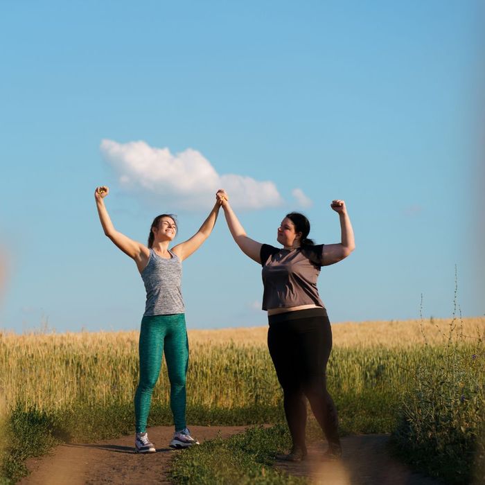 two women celebrating weight loss achievement